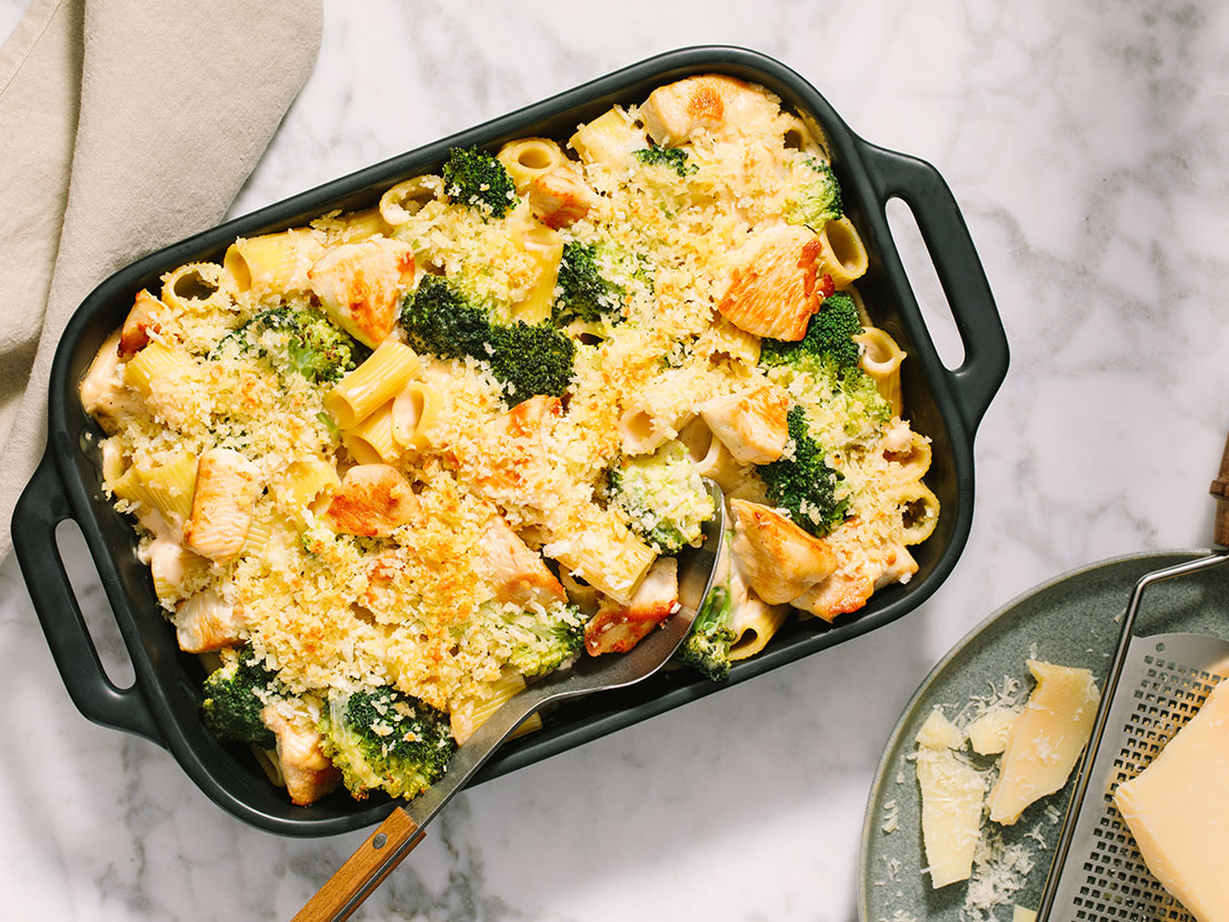An image of prepared Chicken Broccoli Alfredo Bake made with Prego® Homestyle Alfredo Sauce, Parmesan cheese, chicken, penne pasta, broccoli and mozzarella cheese.