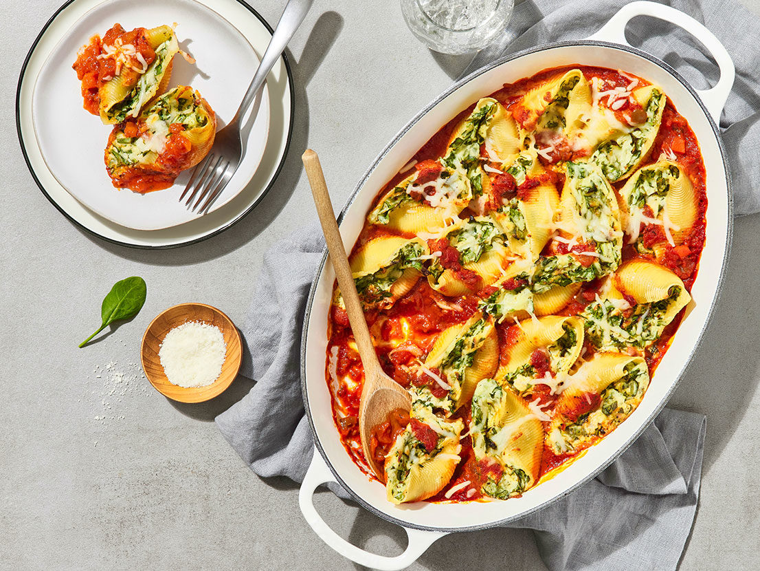 An image of prepared Spinach & Cheese Stuffed Shells made with pasta shells, baby spinach, ricotta cheese, mozzarella cheese, Parmesan cheese and Prego® Italian Sauce.