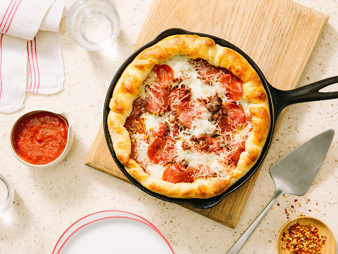 An image of prepared Homemade Deep Dish Pizza with Beef, Pepperoni & Peppers made with ground beef, peppers, onions, Prego® Traditional Sauce, pepperoni and pizza cheese blend.